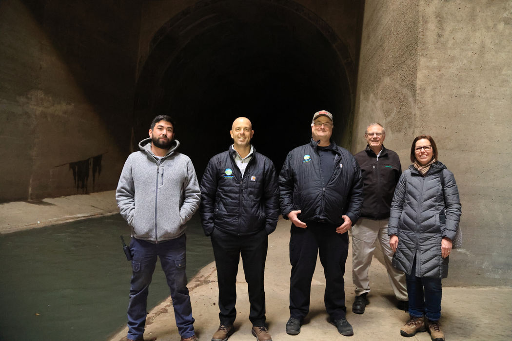 group of team members standing in a tunnel.