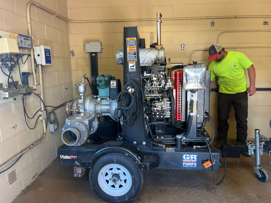 worker looking at a portable pump